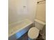 Bathroom with a toilet, tub, and white tile and a built-in shower niche at 8224 Golf Ridge Dr, Charlotte, NC 28277