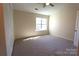 Bedroom with neutral walls and carpet, large window, and closet space at 8224 Golf Ridge Dr, Charlotte, NC 28277