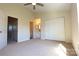 Spacious bedroom with neutral carpet, ceiling fan, and ensuite bathroom access at 8224 Golf Ridge Dr, Charlotte, NC 28277