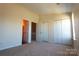 Bedroom with neutral carpet, bright lighting, and ensuite bathroom at 8224 Golf Ridge Dr, Charlotte, NC 28277