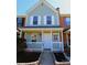 Charming two-story townhome with a quaint front porch, neat landscaping, and inviting curb appeal at 8224 Golf Ridge Dr, Charlotte, NC 28277