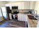 Well-lit kitchen features stainless steel appliances, granite countertops, and modern cabinetry at 8224 Golf Ridge Dr, Charlotte, NC 28277