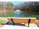 Relax by the pond and enjoy peaceful scenery with seating and a water feature at 8224 Golf Ridge Dr, Charlotte, NC 28277