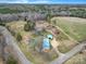 Scenic aerial shot of property showcasing home, outbuildings, and surrounding woods and farmland at 836 Love Rd, Blackstock, SC 29014