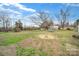 Large backyard with a trampoline and mature trees, perfect for outdoor activities at 836 Love Rd, Blackstock, SC 29014