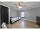 Bedroom features neutral walls, wood floors, a ceiling fan and a black door at 836 Love Rd, Blackstock, SC 29014