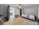 This bedroom features neutral walls, wood floors, a ceiling fan and a black door at 836 Love Rd, Blackstock, SC 29014