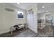 Charming entryway with coat hooks, farmhouse decor and a bench with decorative cowhide at 836 Love Rd, Blackstock, SC 29014