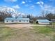 Charming home with a blue roof and a detached garage surrounded by green lawn at 836 Love Rd, Blackstock, SC 29014