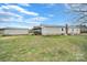 Back exterior view of home with shed and covered back porch at 836 Love Rd, Blackstock, SC 29014