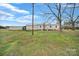 Back exterior view of home with shed and mature trees at 836 Love Rd, Blackstock, SC 29014
