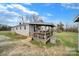 View of covered porch with wood decking and stairs to grade at 836 Love Rd, Blackstock, SC 29014