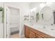 Bathroom featuring a double sink vanity, two mirrors, and a combined shower and tub at 8513 Loxton Cir, Charlotte, NC 28214