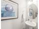 Small powder room featuring a pedestal sink and large decorative art piece at 8513 Loxton Cir, Charlotte, NC 28214