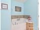 Bright bathroom featuring a soaking tub with grey tile surround at 8513 Loxton Cir, Charlotte, NC 28214