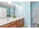 Bathroom featuring a double sink vanity, framed mirror, and bright blue paint at 8513 Loxton Cir, Charlotte, NC 28214