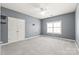 Bedroom featuring plush carpet, a ceiling fan, and a double door closet at 8513 Loxton Cir, Charlotte, NC 28214