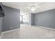 Large bedroom features neutral carpet and a modern accent wall at 8513 Loxton Cir, Charlotte, NC 28214