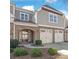 Traditional brick and siding townhome with a two-car garage and manicured landscaping at 8513 Loxton Cir, Charlotte, NC 28214