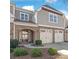 Attractive townhome with brick and gray wood exterior, dual garage and inviting arched front entry at 8513 Loxton Cir, Charlotte, NC 28214