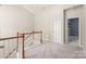 Hallway with grey carpet and a closet with shelving inside at 8513 Loxton Cir, Charlotte, NC 28214