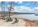 Lakeside lounging area featuring chairs and a tranquil view of the lake and boat docks at 8513 Loxton Cir, Charlotte, NC 28214