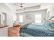 Comfortable main bedroom featuring a tray ceiling, hardwood floors, and a cozy sitting area at 8513 Loxton Cir, Charlotte, NC 28214