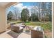 Outdoor patio with comfortable seating and views of the lush, green backyard at 8513 Loxton Cir, Charlotte, NC 28214