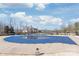 A community pool covered for the off-season sits alongside a charming pool house under a bright sky at 8513 Loxton Cir, Charlotte, NC 28214