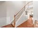 Bright staircase featuring hardwood floors, white trim, decorative molding and a wooden handrail at 8513 Loxton Cir, Charlotte, NC 28214