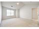 A spacious bedroom features neutral carpet, a ceiling fan, a large window and white trim at 8929 Bryant Field Cir, Charlotte, NC 28277
