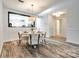 Open dining area with modern lighting, wood floors, and neutral paint at 8929 Bryant Field Cir, Charlotte, NC 28277