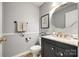 Half bath with a black vanity, gray walls, and neutral decor at 8929 Bryant Field Cir, Charlotte, NC 28277