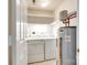 A utility area features a washer, dryer, water heater, and storage shelving at 8929 Bryant Field Cir, Charlotte, NC 28277