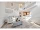 Bright living room features wood floors, a large area rug, and an open staircase to the second floor at 8929 Bryant Field Cir, Charlotte, NC 28277