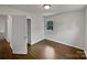 Bedroom featuring hardwood floors, a closet, and window with a view of the yard at 924 Springdale Ln, Gastonia, NC 28052