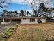 Charming single-story home with a carport, painted white exterior and a well-manicured front yard at 924 Springdale Ln, Gastonia, NC 28052