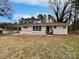 Charming single-story home with a carport, painted white exterior and a well-manicured front yard at 924 Springdale Ln, Gastonia, NC 28052