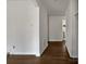 Bright hallway featuring hardwood floors, neutral paint, and access to the bathroom at 924 Springdale Ln, Gastonia, NC 28052