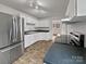 Well-equipped kitchen with stainless steel appliances, white cabinets, and dark countertops at 924 Springdale Ln, Gastonia, NC 28052