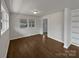 Sunlit living room featuring hardwood floors and a large window overlooking the front yard at 924 Springdale Ln, Gastonia, NC 28052