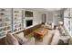 Bright, staged living room with fireplace, built-in shelves, hardwood floors, and neutral-toned furniture at 924 Springdale Ln, Gastonia, NC 28052