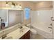 Well-lit bathroom features a double sink vanity and shower-tub combination at 9503 Rocky Spring Nw Ct, Concord, NC 28027