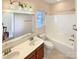 Bright bathroom featuring double sinks, a bathtub, and a large mirror at 9503 Rocky Spring Nw Ct, Concord, NC 28027