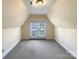 Versatile bonus room with a neutral carpet and access to the balcony at 9503 Rocky Spring Nw Ct, Concord, NC 28027