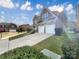 Charming brick residence with a well-kept lawn, a two-car garage, and a quaint balcony under a sunny sky at 9503 Rocky Spring Nw Ct, Concord, NC 28027