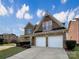 Handsome brick home featuring a two-car garage, a balcony, and meticulous landscaping under a partly cloudy sky at 9503 Rocky Spring Nw Ct, Concord, NC 28027