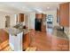 Open-concept kitchen with granite countertops, stainless steel appliances, and hardwood floors at 9503 Rocky Spring Nw Ct, Concord, NC 28027