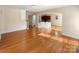 Open-concept living room with hardwood flooring and plenty of natural light at 9503 Rocky Spring Nw Ct, Concord, NC 28027