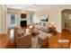 Beautifully staged living room with hardwood floors, fireplace, and neutral decor at 9503 Rocky Spring Nw Ct, Concord, NC 28027